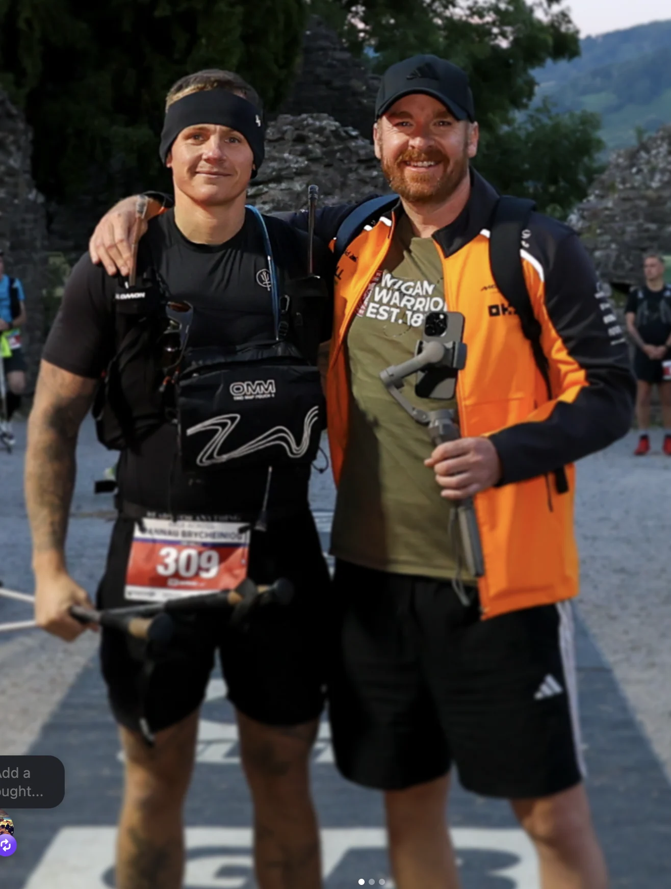 Jimmy beside another runner beneath the Beacons Way race arch