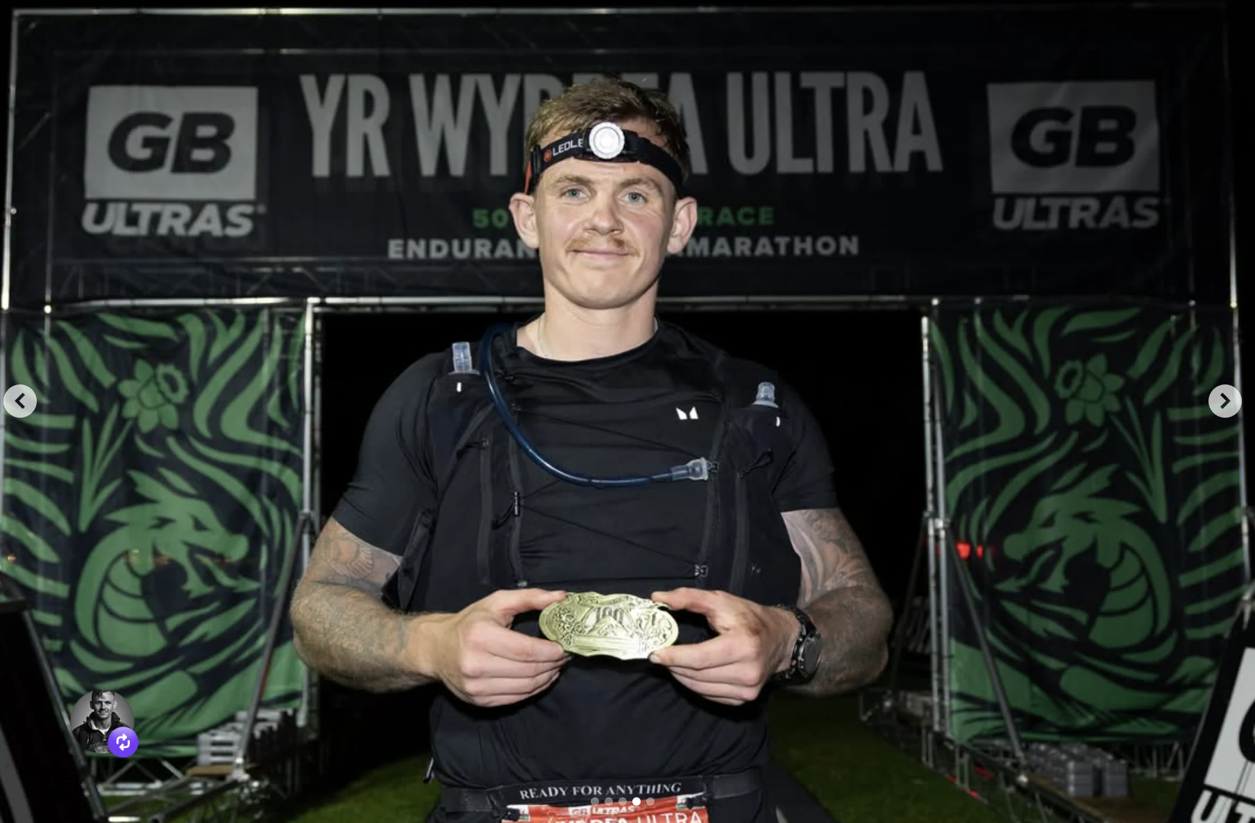 Jimmy holding a medal at the Yr Wyddfa Ultra finish