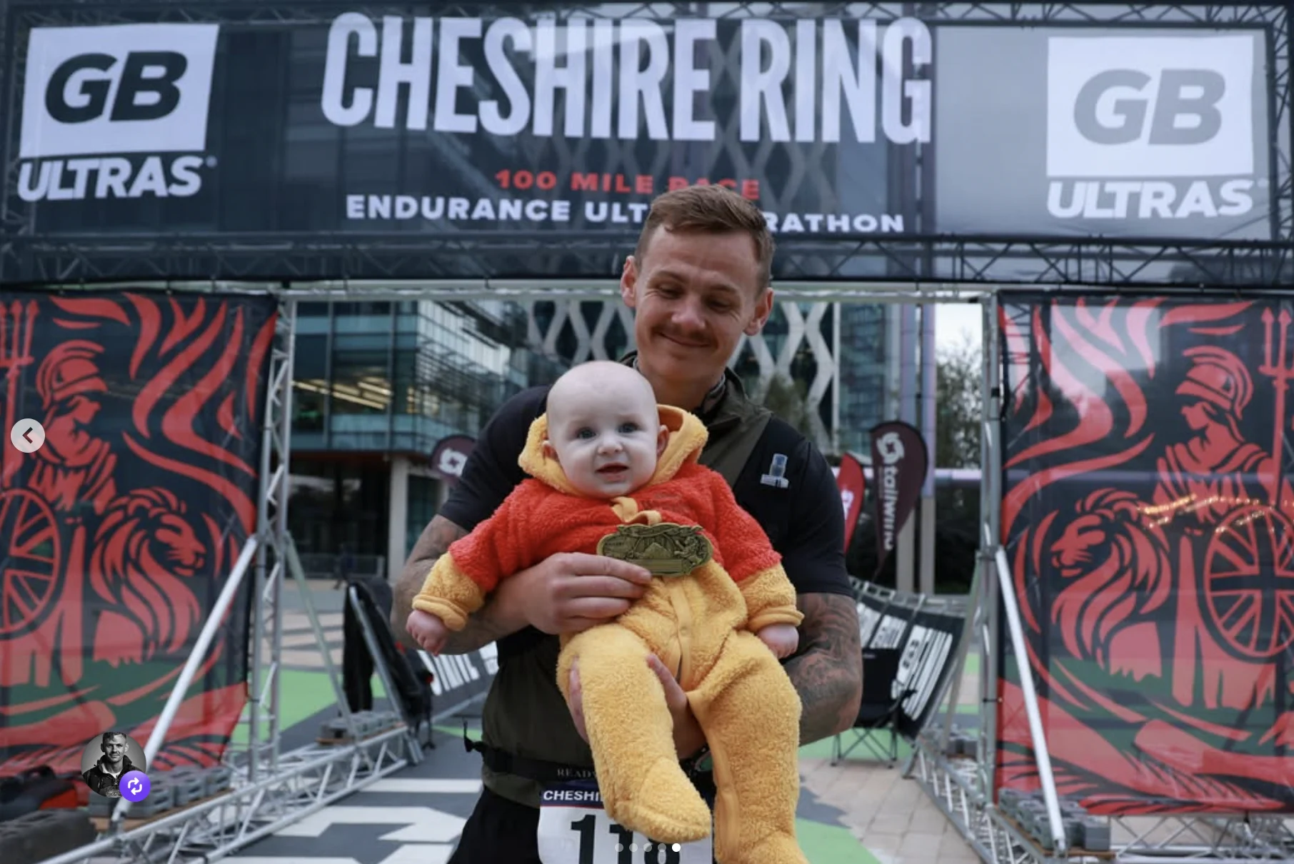 Jimmy holding a baby and a medal at the Cheshire Ring finish