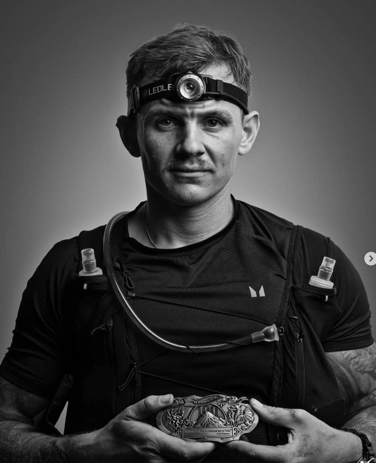 Jimmy wearing a head torch and holding a medal